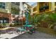 This courtyard features a green picnic table and mature landscaping at 2010 E Palm Ave # 15210, Tampa, FL 33605