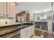 Modern kitchen with stainless steel sink, white cabinets, and a view into the dining area at 2010 E Palm Ave # 15210, Tampa, FL 33605