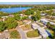 Aerial view of a charming home located near a tranquil lake, surrounded by mature trees at 2028 Pine Ridge Dr, Clearwater, FL 33763