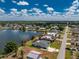 Aerial view of the property showcasing the pool, lanai, landscaping, and lake views at 22322 Tennyson Ave, Port Charlotte, FL 33954