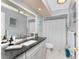 Bathroom with vanity sink, modern fixtures, gray cabinets, granite countertop, and shower at 22322 Tennyson Ave, Port Charlotte, FL 33954