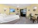 Inviting bedroom boasts access to the screened lanai, neutral walls, and tile flooring at 22322 Tennyson Ave, Port Charlotte, FL 33954