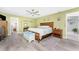 Inviting primary bedroom with wooden furniture and a ceiling fan at 22322 Tennyson Ave, Port Charlotte, FL 33954