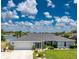 Charming single-story home with well-manicured lawn and lush landscaping located on a waterfront property at 22322 Tennyson Ave, Port Charlotte, FL 33954