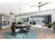 Screened in lanai featuring a dining area, access to the pool, and views of the surrounding lake at 22322 Tennyson Ave, Port Charlotte, FL 33954