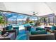 Large screened in lanai featuring a seating area, view of the pool, and access to the lake at 22322 Tennyson Ave, Port Charlotte, FL 33954