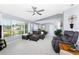 Bright living room with a large window, comfortable seating, and neutral decor at 22322 Tennyson Ave, Port Charlotte, FL 33954
