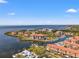 Gorgeous aerial view of waterfront condos with boat docks and lush landscaping on a sunny day at 234 Mariner Dr # 234, Tarpon Springs, FL 34689