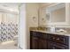 Bathroom with vanity with granite counter, floral shower curtain, and tiled floor at 234 Mariner Dr # 234, Tarpon Springs, FL 34689