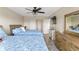 Bedroom features two twin beds, ceiling fan, dresser, and a view of the room's closets at 234 Mariner Dr # 234, Tarpon Springs, FL 34689
