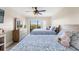 Bedroom features a ceiling fan, and a sliding glass door to a balcony with a view at 234 Mariner Dr # 234, Tarpon Springs, FL 34689