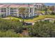 Condominium exterior features balconies, waterway access, and well-maintained landscaping near the parking area at 234 Mariner Dr # 234, Tarpon Springs, FL 34689
