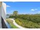 Exterior view features a paved walkway and lush landscaping leading to the water at 234 Mariner Dr # 234, Tarpon Springs, FL 34689