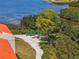 Exterior aerial features lush trees, paved walkway, and water view with kayaks at 234 Mariner Dr # 234, Tarpon Springs, FL 34689