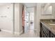 Hallway with tiled flooring, view of bedroom through doorway, vanity with granite counter at 234 Mariner Dr # 234, Tarpon Springs, FL 34689