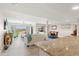 Open-concept living room with modern chandelier, island seating, and an open view to the dining room at 234 Mariner Dr # 234, Tarpon Springs, FL 34689