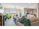 Bright living room with modern chandelier, plants and a large window with a beautiful outdoor view at 234 Mariner Dr # 234, Tarpon Springs, FL 34689