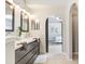 Stylish bathroom with a sleek vanity, modern mirrors, and an archway leading to the bedroom at 24941 Ravello St, Land O Lakes, FL 34639