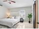 Serene bedroom with a plush bed, soft lighting, and a modern ceiling fan for ultimate comfort at 24941 Ravello St, Land O Lakes, FL 34639