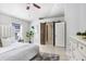 Bright bedroom featuring a sliding barn door and updated ensuite access at 24941 Ravello St, Land O Lakes, FL 34639