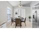 Bright dining area featuring a modern chandelier, neutral tones, and stainless steel appliances, perfect for casual dining at 24941 Ravello St, Land O Lakes, FL 34639