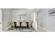 Dining area with a modern table setting, tile floors, and arched doorways leading to other living spaces at 24941 Ravello St, Land O Lakes, FL 34639