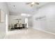 Large living and dining areas with neutral paint, ceiling fan, and tile flooring at 24941 Ravello St, Land O Lakes, FL 34639
