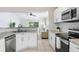 Modern kitchen with white cabinets, granite countertops and stainless steel appliances at 24941 Ravello St, Land O Lakes, FL 34639