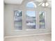 Sunlit living room boasting a ceiling fan and three large windows, creating a bright and airy atmosphere at 24941 Ravello St, Land O Lakes, FL 34639