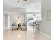 Open-concept living room with tile flooring, neutral paint and two accent chairs at 24941 Ravello St, Land O Lakes, FL 34639
