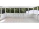 Enclosed patio with large windows letting in natural light and tile flooring at 24941 Ravello St, Land O Lakes, FL 34639