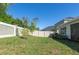 Fenced backyard featuring a grass lawn and stone perimeter fence at 2516 Leafwing Ct, Palm Harbor, FL 34683