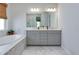 Bright bathroom featuring marble floors, double sink vanity, soaking tub, and lots of natural light at 2516 Leafwing Ct, Palm Harbor, FL 34683