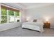Relaxing bedroom with tray ceiling, neutral tones, and a large window at 2516 Leafwing Ct, Palm Harbor, FL 34683