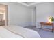 Relaxing bedroom featuring a tray ceiling, carpet flooring, and a console table at 2516 Leafwing Ct, Palm Harbor, FL 34683