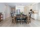 View of open dining area adjacent to modern kitchen with stainless steel appliances at 2516 Leafwing Ct, Palm Harbor, FL 34683