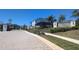 Community entrance featuring a stone and iron gate with attractive landscaping at 2516 Leafwing Ct, Palm Harbor, FL 34683