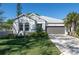 Charming single-story home with a well-manicured lawn and a two-car garage at 2516 Leafwing Ct, Palm Harbor, FL 34683