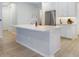 This kitchen boasts a large island with stone countertops and room for seating at 2516 Leafwing Ct, Palm Harbor, FL 34683
