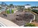 Exterior neighborhood playground featuring modern equipment and cushioned ground at 2516 Leafwing Ct, Palm Harbor, FL 34683