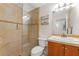 Bright bathroom with tiled shower and a single sink vanity at 2700 Bayshore Blvd # 512, Dunedin, FL 34698