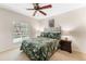 Bedroom featuring a dark-colored metal headboard and leafy green linens at 2700 Bayshore Blvd # 512, Dunedin, FL 34698