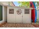 Outdoor shed with decorative sun and moon art with kayak storage on the side at 2700 Bayshore Blvd # 512, Dunedin, FL 34698
