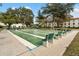 Well-maintained shuffleboard court surrounded by mature trees and lush landscaping at 2700 Bayshore Blvd # 512, Dunedin, FL 34698