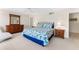 Bedroom boasts soft lighting, carpet, and wooden furniture at 2700 Bayshore Blvd # 512, Dunedin, FL 34698