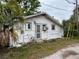 Exterior view of a small single-Gathering home with overgrown foliage at 3029 20Th St, St Petersburg, FL 33713