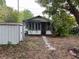 Charming single-Gathering home featuring a red door, a shed, and large windows at 3029 20Th St, St Petersburg, FL 33713