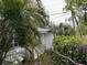 A partial side view showcases the architecture of the home surrounded by lush greenery at 3029 20Th St, St Petersburg, FL 33713