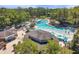Aerial community view showcasing Lochness Pool, clubhouse, and lush greenery providing a resort-like experience at 36750 Us 19 N # 2763, Palm Harbor, FL 34684