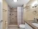 This bathroom has a walk-in shower with stylish tile and a granite countertop on the vanity sink at 36750 Us 19 N # 2763, Palm Harbor, FL 34684